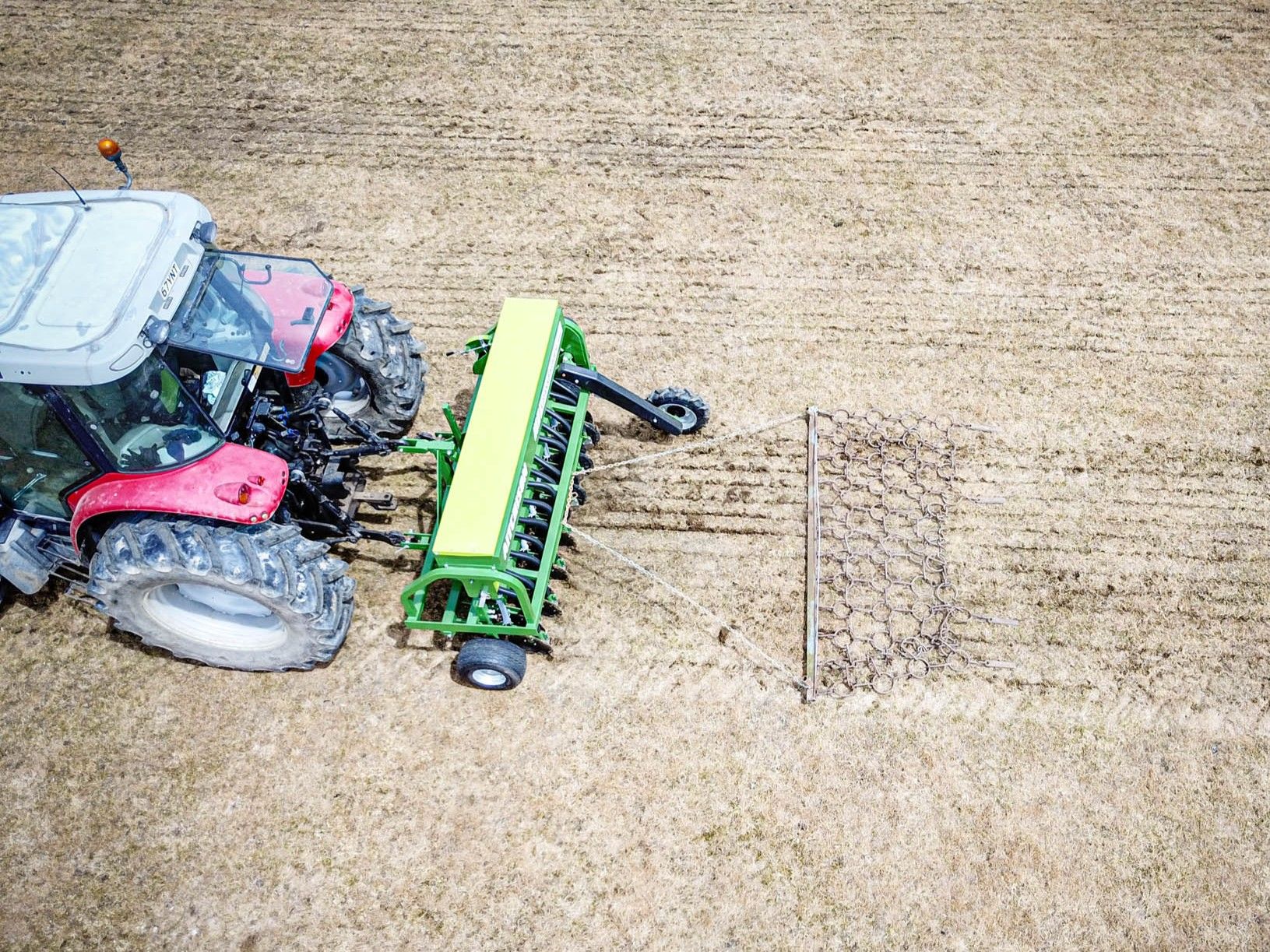 erial view of Aitchison GrassFarmer disc seed drill creating clean furrows in pasture