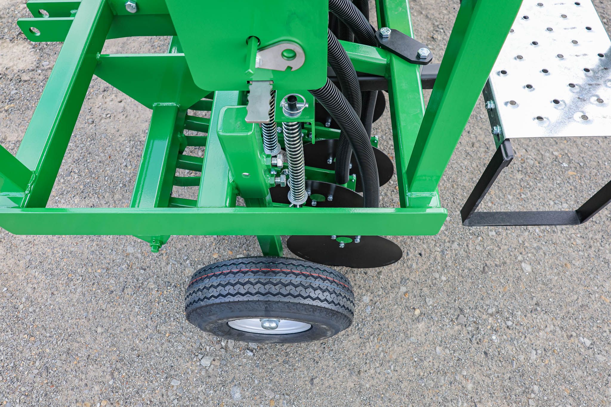 Closeup showing the disc seed drill depth control legs enabling farmers to easily set their desired sowing depth.