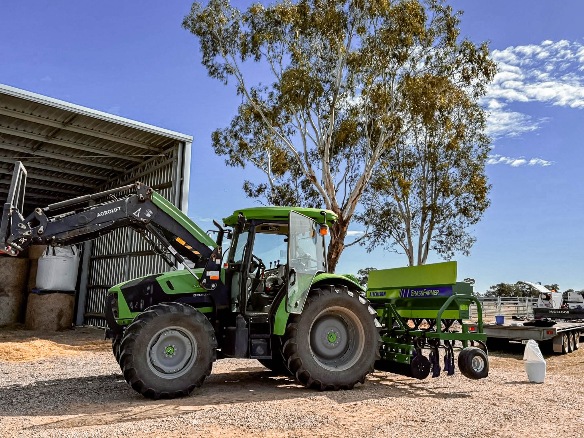 Aitchison GrassFarmer® (old livery) on the tractor linkages, shown in the process of setting and calibrating seed rates.