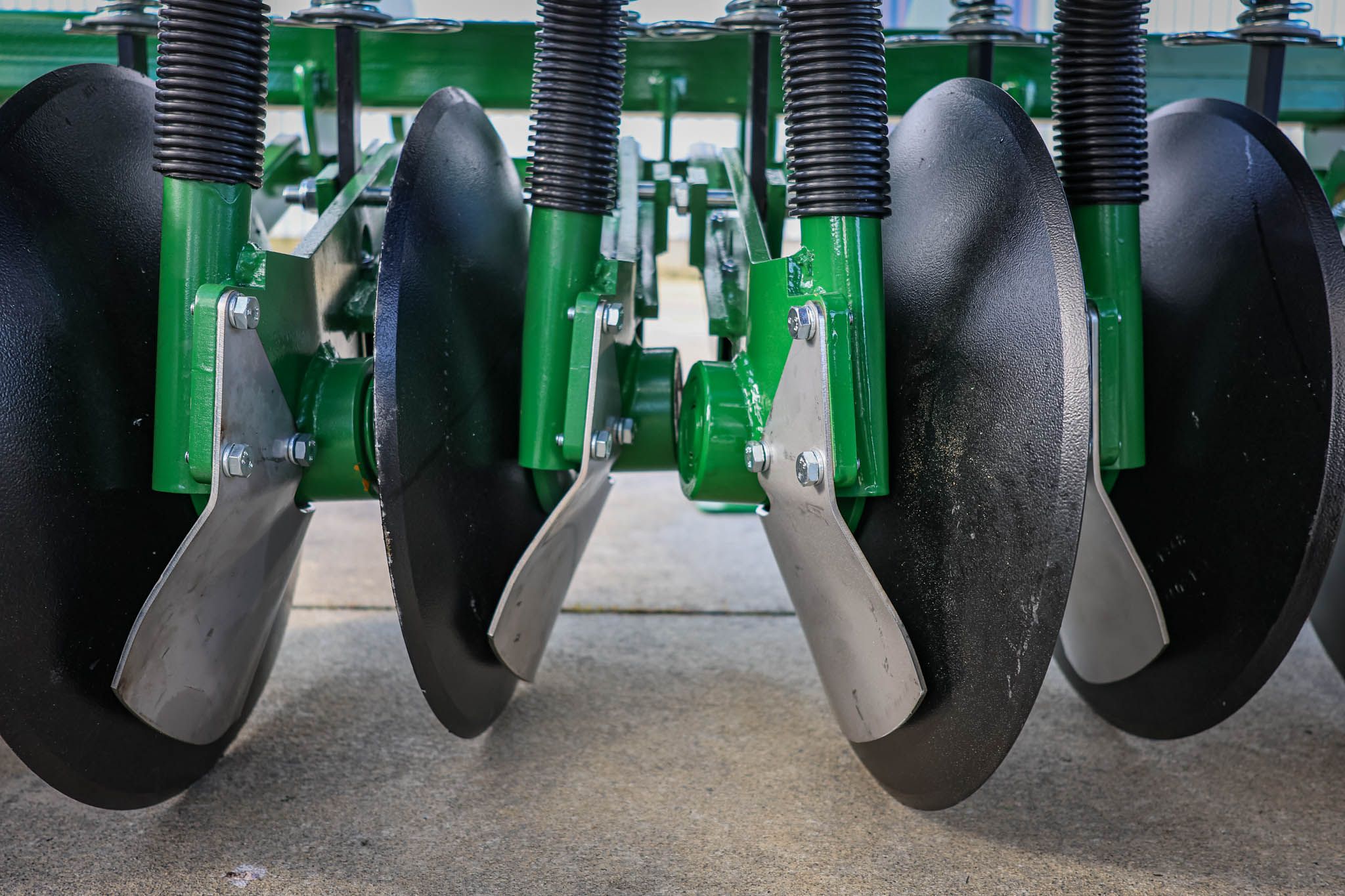 A photo showing the the large 14" concave discs on the GrassFarmer disc drill.