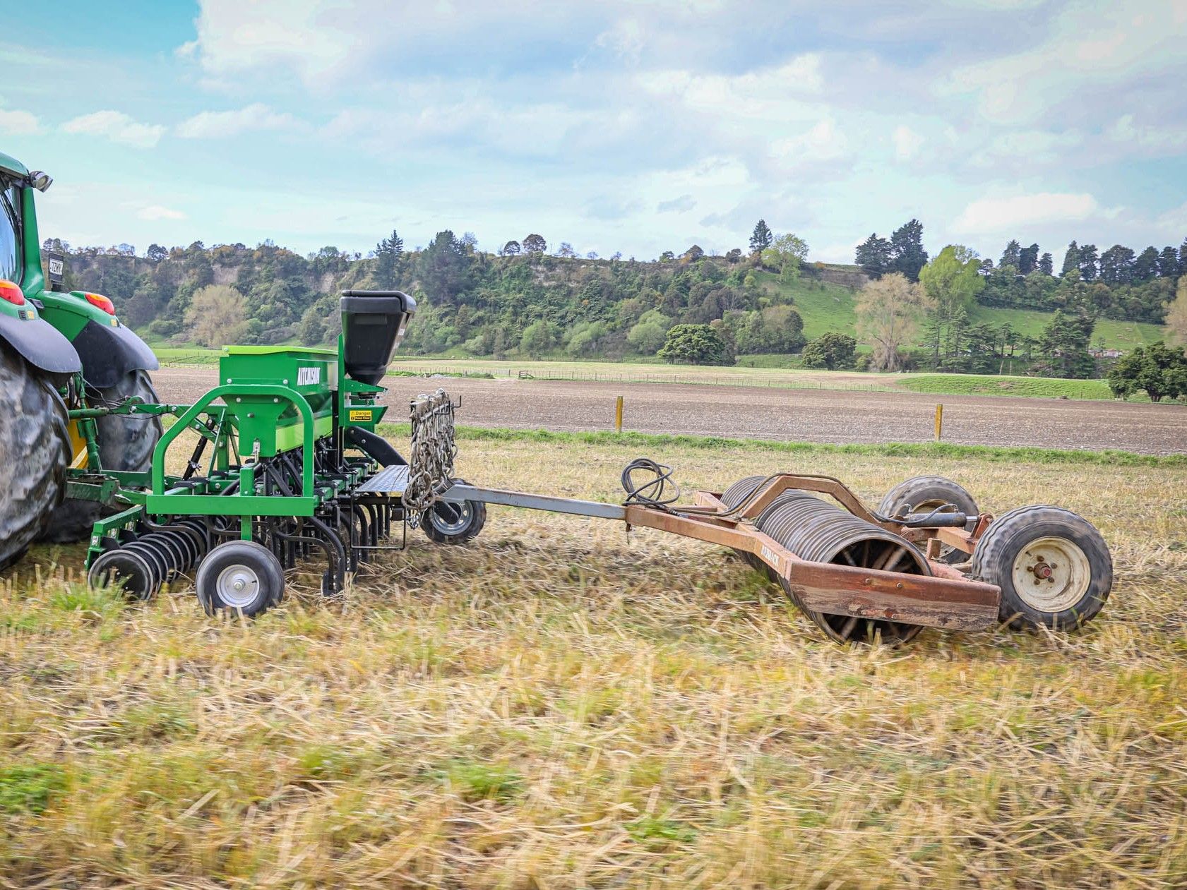 GrassFarmer® fitted with the tread board upgrade, with the cover roller being towed behind, pressing soil for maximum seed-to-soil contact.